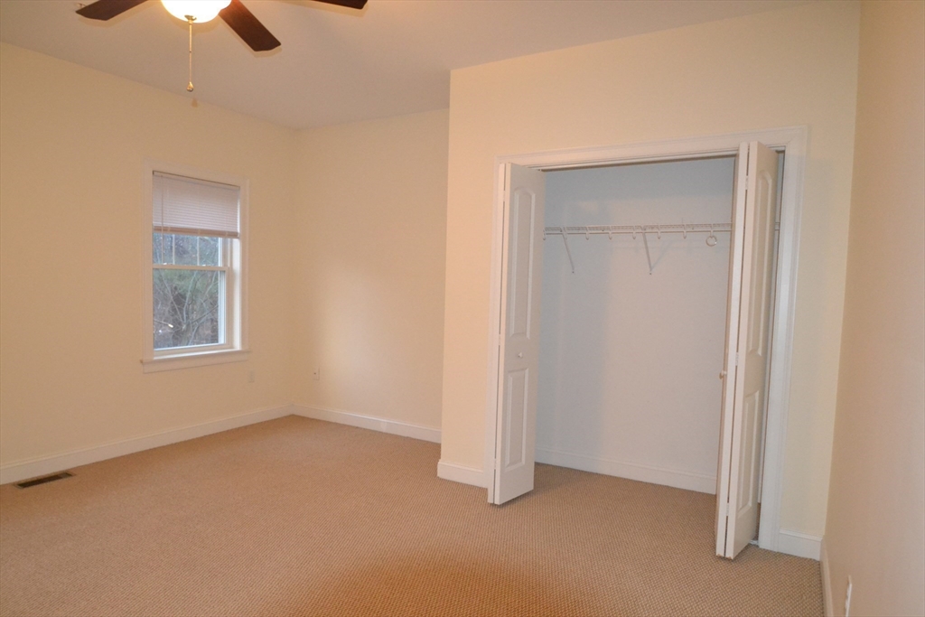 8 Cheyenne Valley, Unit 8 Westford, MA 01886 - Photo 19 of 27 a view of an empty room with chandelier fan