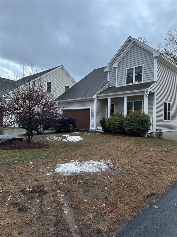 8 Cheyenne Valley, Unit 8 Westford, MA 01886 - Photo 26 of 27 a front view of a house with a garden and trees
