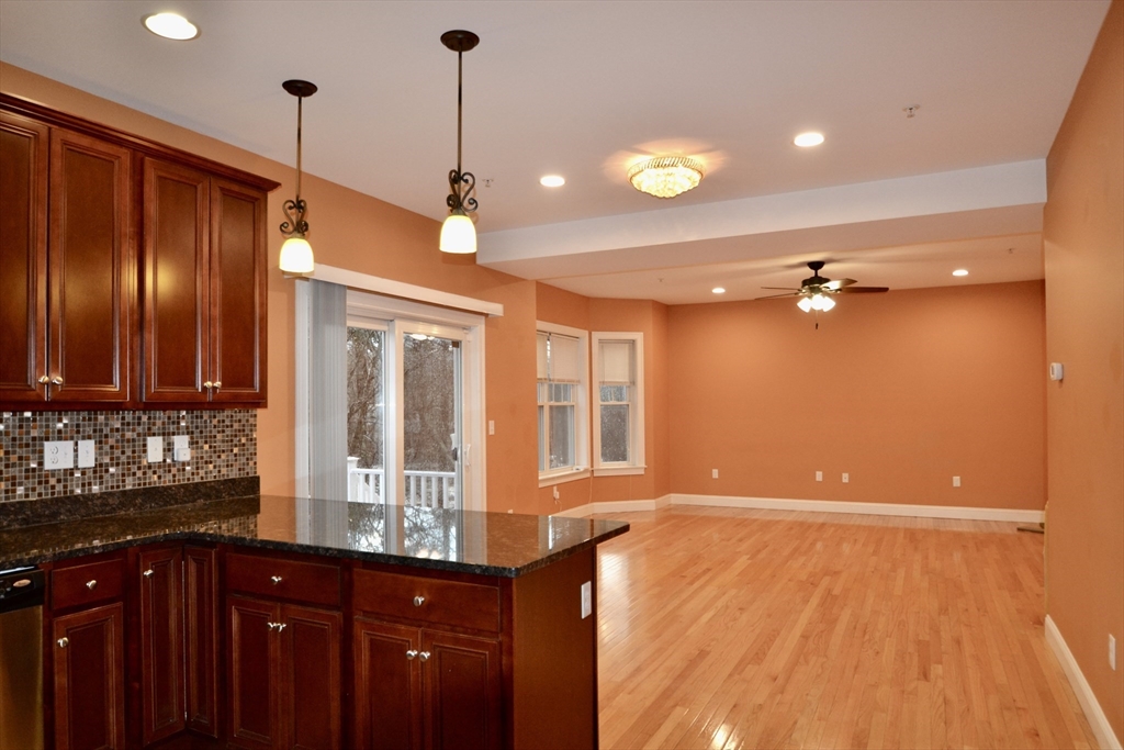 8 Cheyenne Valley, Unit 8 Westford, MA 01886 - Photo 7 of 27 a view of a kitchen with stainless steel appliances granite countertop wooden cabinets and a sink