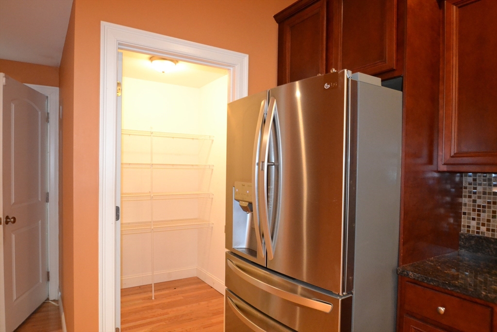 8 Cheyenne Valley, Unit 8 Westford, MA 01886 - Photo 8 of 27 a view of a refrigerator and an entryway