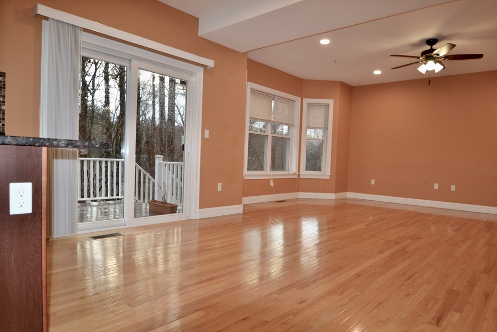 8 Cheyenne Valley, Unit 8 Westford, MA 01886 - Photo 9 of 27 a view of an empty room with a window and wooden floor
