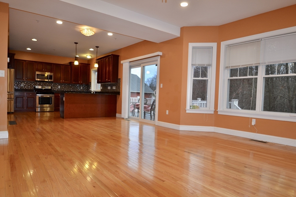8 Cheyenne Valley, Unit 8 Westford, MA 01886 - Photo 10 of 27 a view of a kitchen with stainless steel appliances wooden floor and a large window