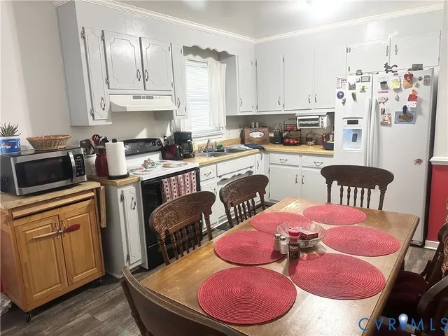 a kitchen with a sink appliances and cabinets