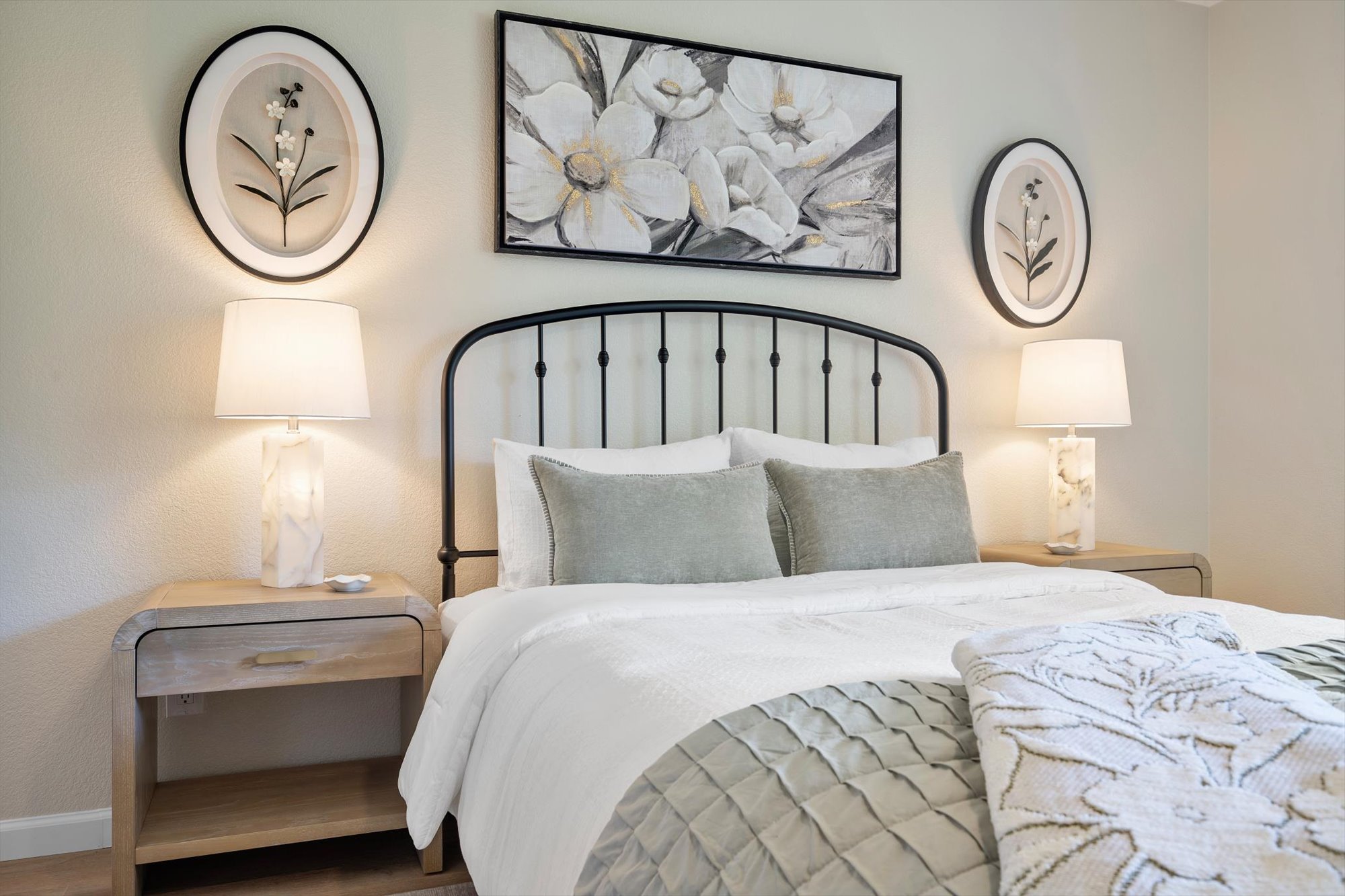 109 Woodland Road Georgetown, TX 78628 - Photo 23 of 40 An inviting sleeping space with warm lighting and a classic wrought iron headboard.