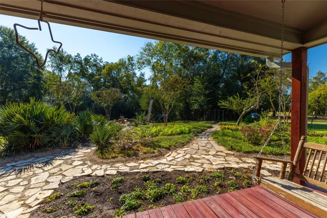 a view of backyard with plants and outdoor seating