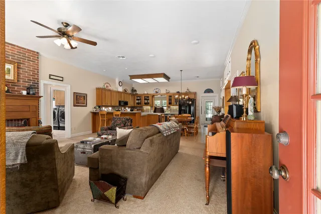 a living room with furniture and a chandelier