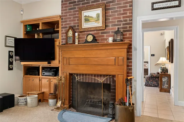 a living room with a fireplace a flat screen tv and a fireplace