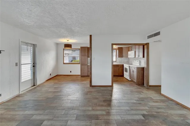 a view of a kitchen cabinets and wooden floor windows