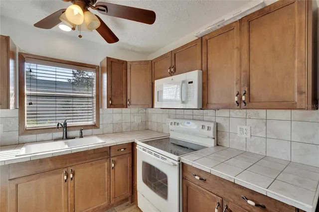 a kitchen with a sink cabinets and window