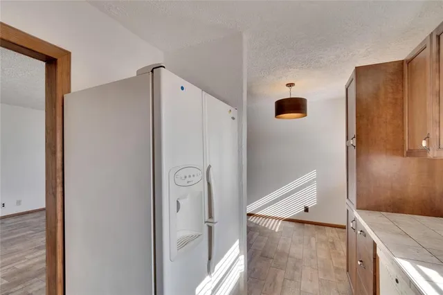 a view of a kitchen from a hallway
