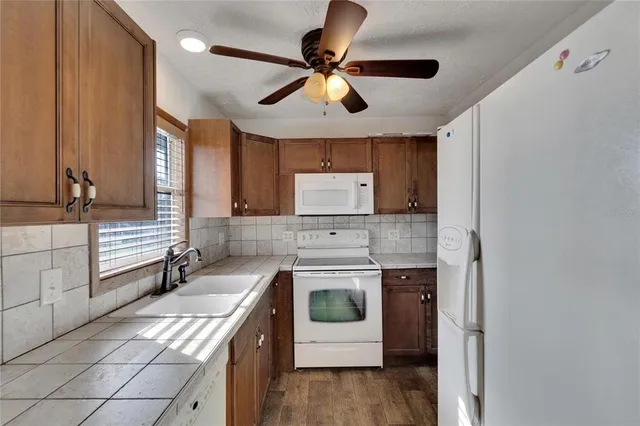 a kitchen with a stove sink and a refrigerator