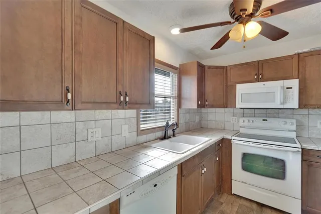 a kitchen with a sink cabinets and window