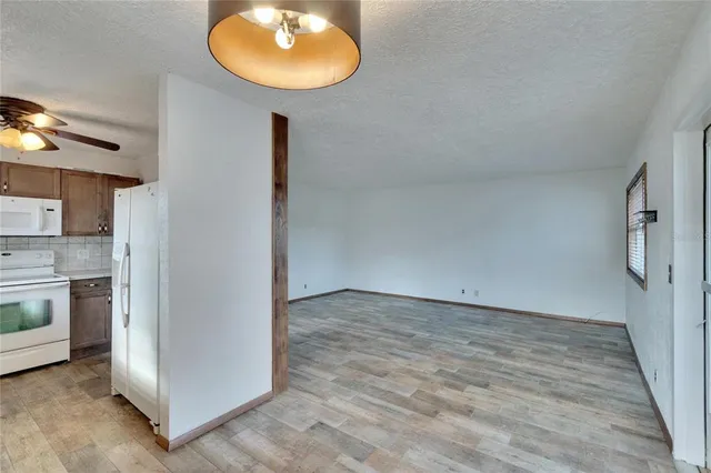 a view of a kitchen with a sink and a refrigerator