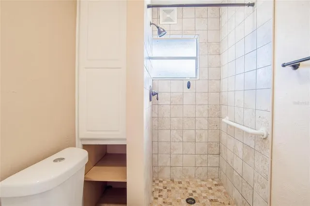 a bathroom with a toilet and shower