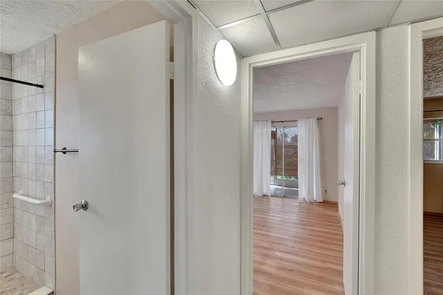 a view of a hallway with wooden floor