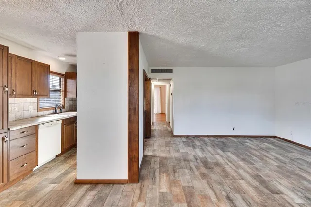 a view of a kitchen with wooden floor and a sink