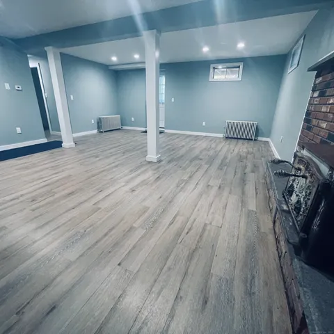 an empty room with wooden floor and entrance