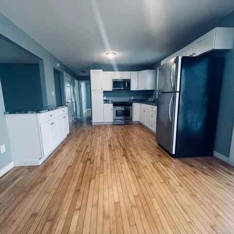 a kitchen with stainless steel appliances a refrigerator and a stove top oven