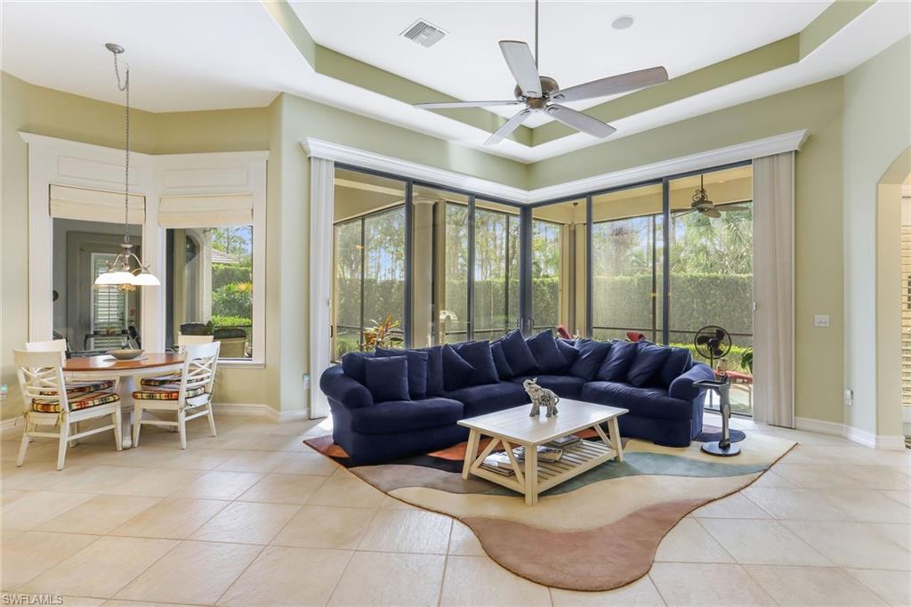 7433 Byrons Way Naples, FL 34113 - Photo 13 of 34 a living room with furniture and a large window