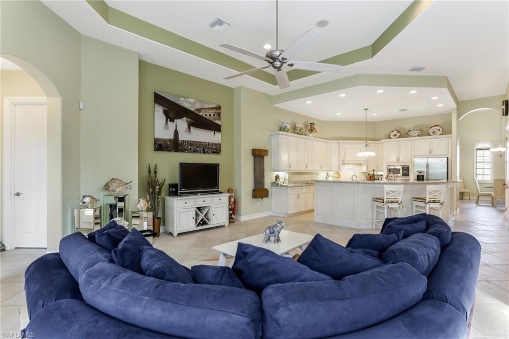 7433 Byrons Way Naples, FL 34113 - Photo 15 of 34 a living room with furniture kitchen and a chandelier