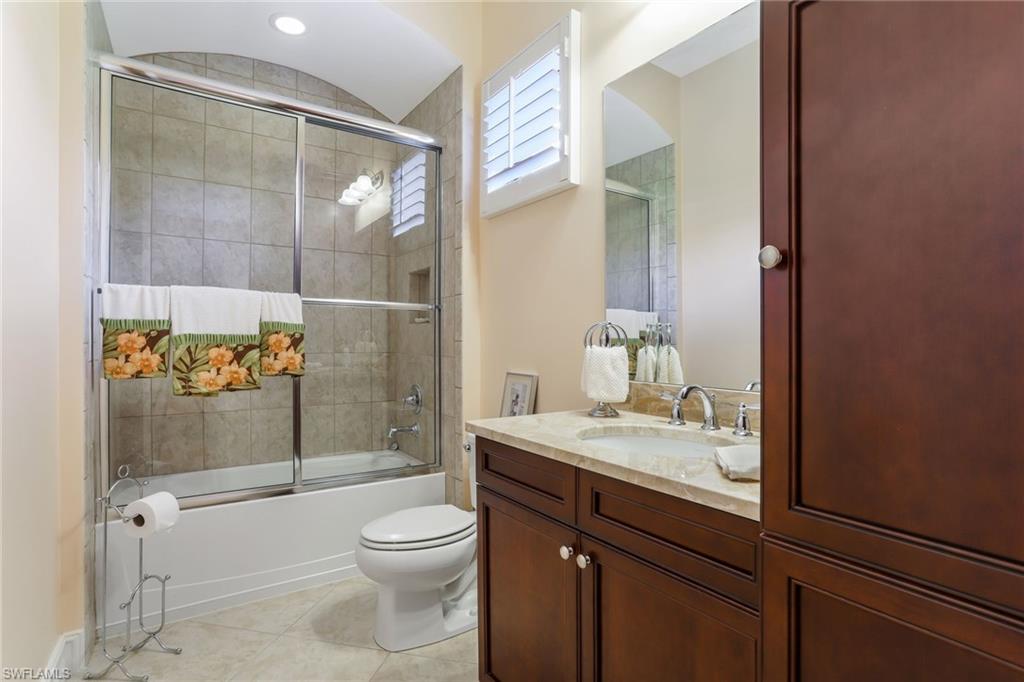 7433 Byrons Way Naples, FL 34113 - Photo 23 of 34 a bathroom with a granite countertop sink toilet and shower
