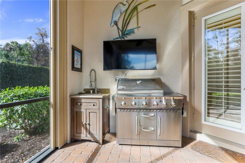 7433 Byrons Way Naples, FL 34113 - Photo 26 of 34 a kitchen with a stove and a sink