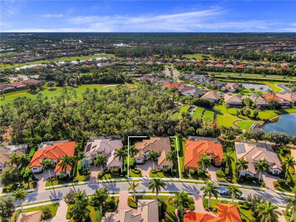 7433 Byrons Way Naples, FL 34113 - Photo 3 of 34 an aerial view of residential houses with outdoor space and trees