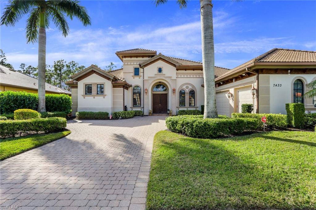 7433 Byrons Way Naples, FL 34113 - Photo 6 of 34 a front view of a house with a garden and yard
