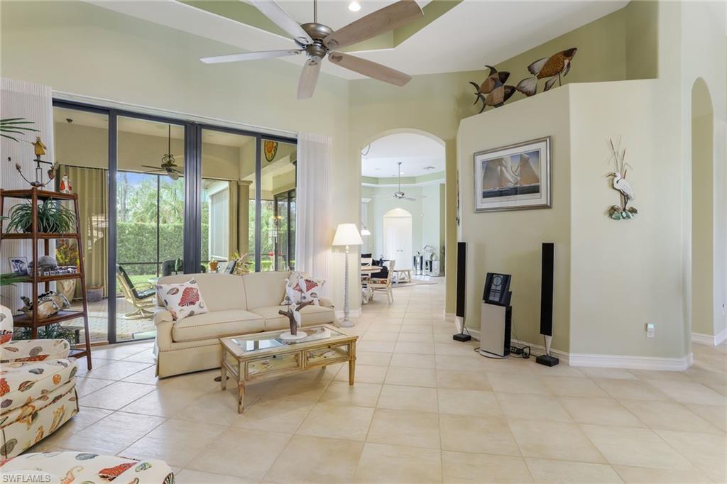 7433 Byrons Way Naples, FL 34113 - Photo 10 of 34 a living room with fireplace furniture and a floor to ceiling window