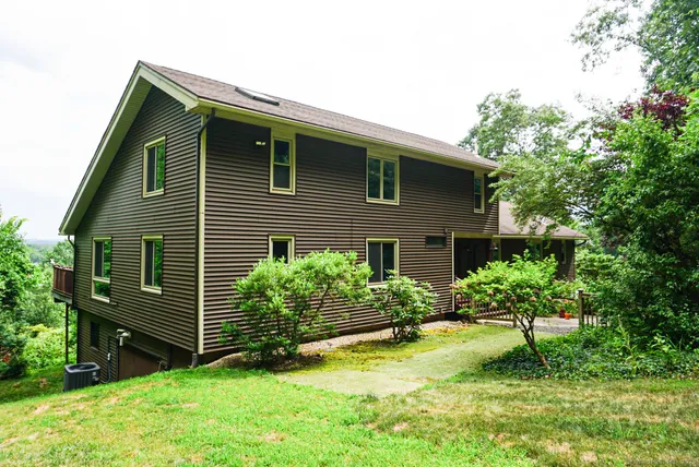 a view of a house with a yard and plants