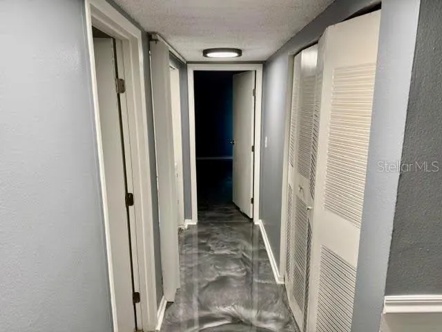 a view of a hallway with wooden floor and entryway