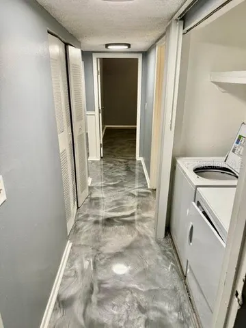a view of a storage and utility room with refrigerator