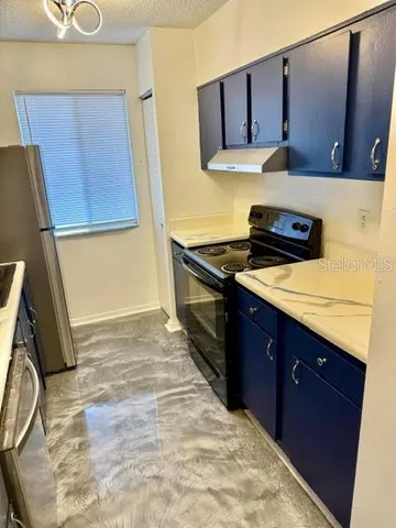 a kitchen with a sink stove and cabinets