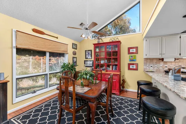 a dining room with furniture and a window