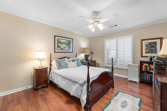 a bedroom with a bed and a bookshelf