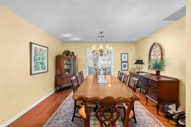 a dining room with furniture window and wooden floor