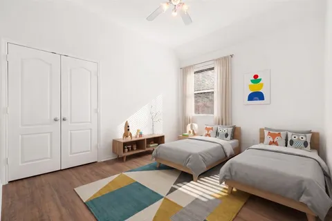a bedroom with two beds and a window