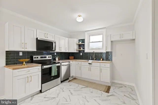 a kitchen with a sink stove and microwave