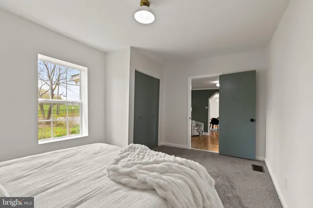 a bedroom with a bed and a window