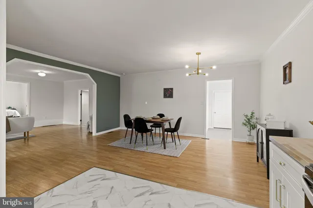 a view of a dining room with furniture and chandelier