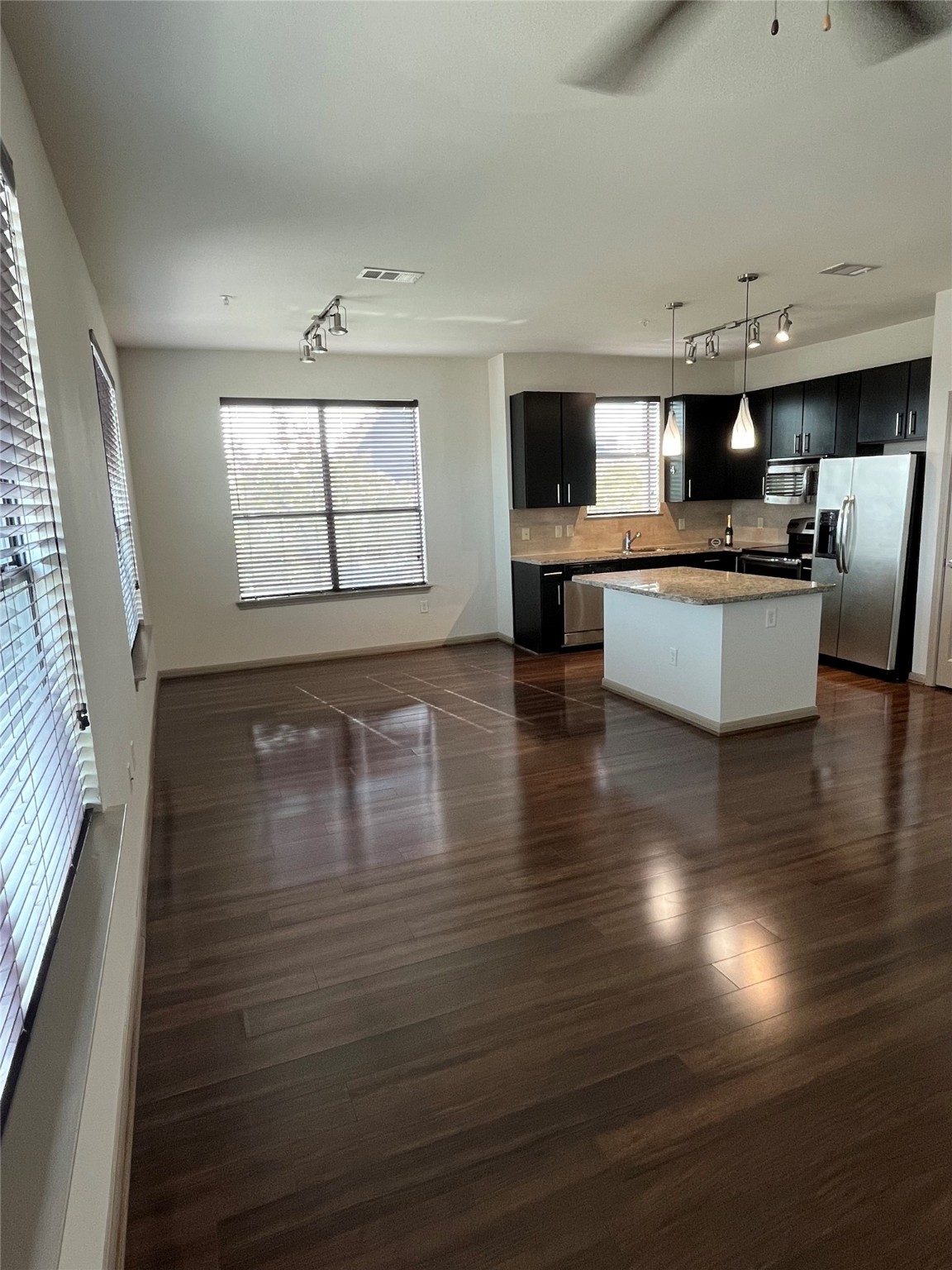 2700 Brazos Street, Unit 4515 Houston, TX 77006 - Photo 4 of 20 wooden floor with kitchen view and living room