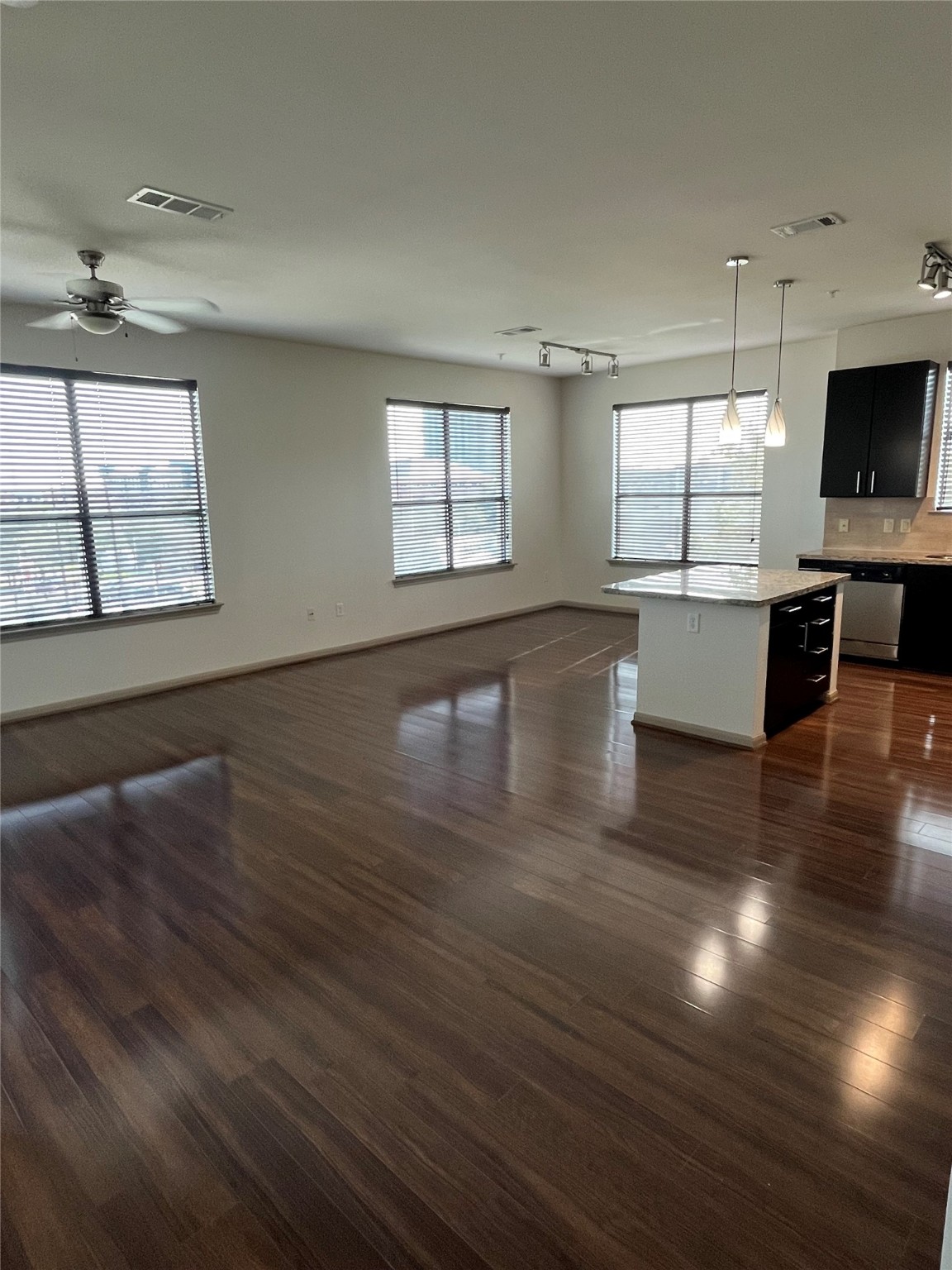 2700 Brazos Street, Unit 4515 Houston, TX 77006 - Photo 5 of 20 an empty room with wooden floor and windows