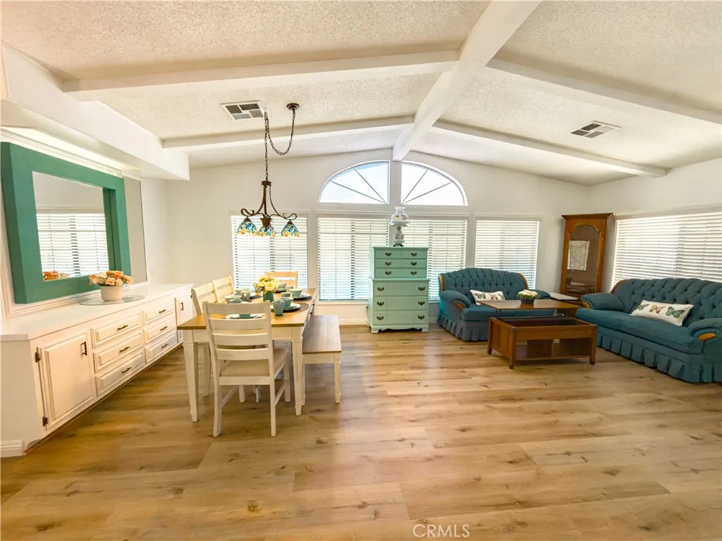 840 East Foothill Boulevard, Unit 203 Azusa, CA 91702 - Photo 11 of 45 a living room with furniture two window and a dining table