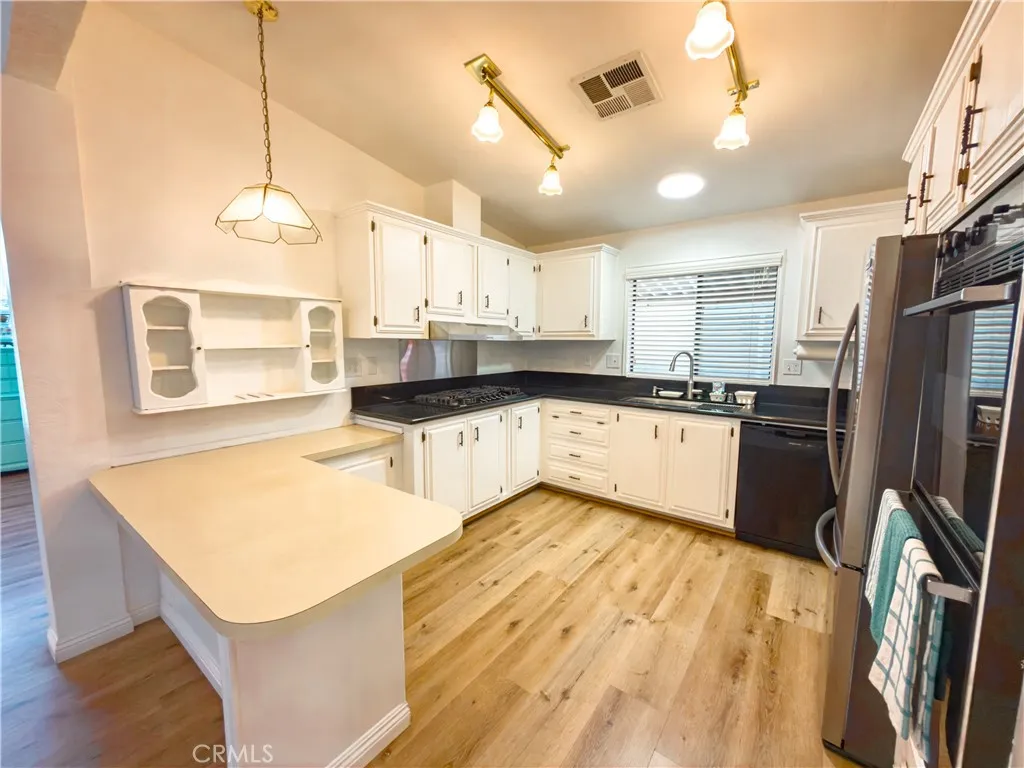 840 East Foothill Boulevard, Unit 203 Azusa, CA 91702 - Photo 15 of 45 a kitchen with stainless steel appliances granite countertop a sink a stove and refrigerator