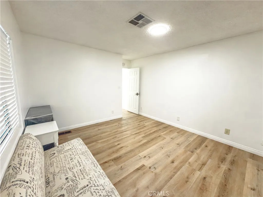840 East Foothill Boulevard, Unit 203 Azusa, CA 91702 - Photo 17 of 45 a view of a bedroom with wooden floor and bedroom