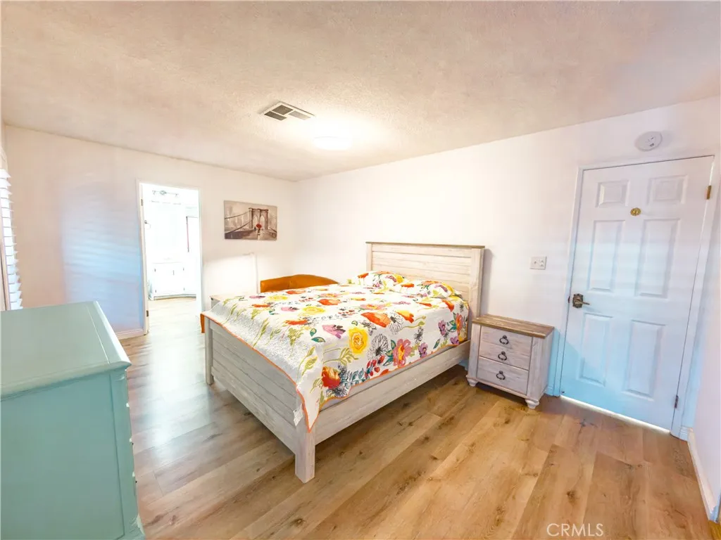 840 East Foothill Boulevard, Unit 203 Azusa, CA 91702 - Photo 19 of 45 a bedroom with a bed and a chair