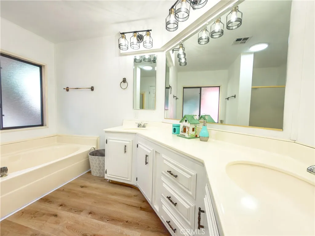 840 East Foothill Boulevard, Unit 203 Azusa, CA 91702 - Photo 22 of 45 a spacious bathroom with a tub sink and mirror
