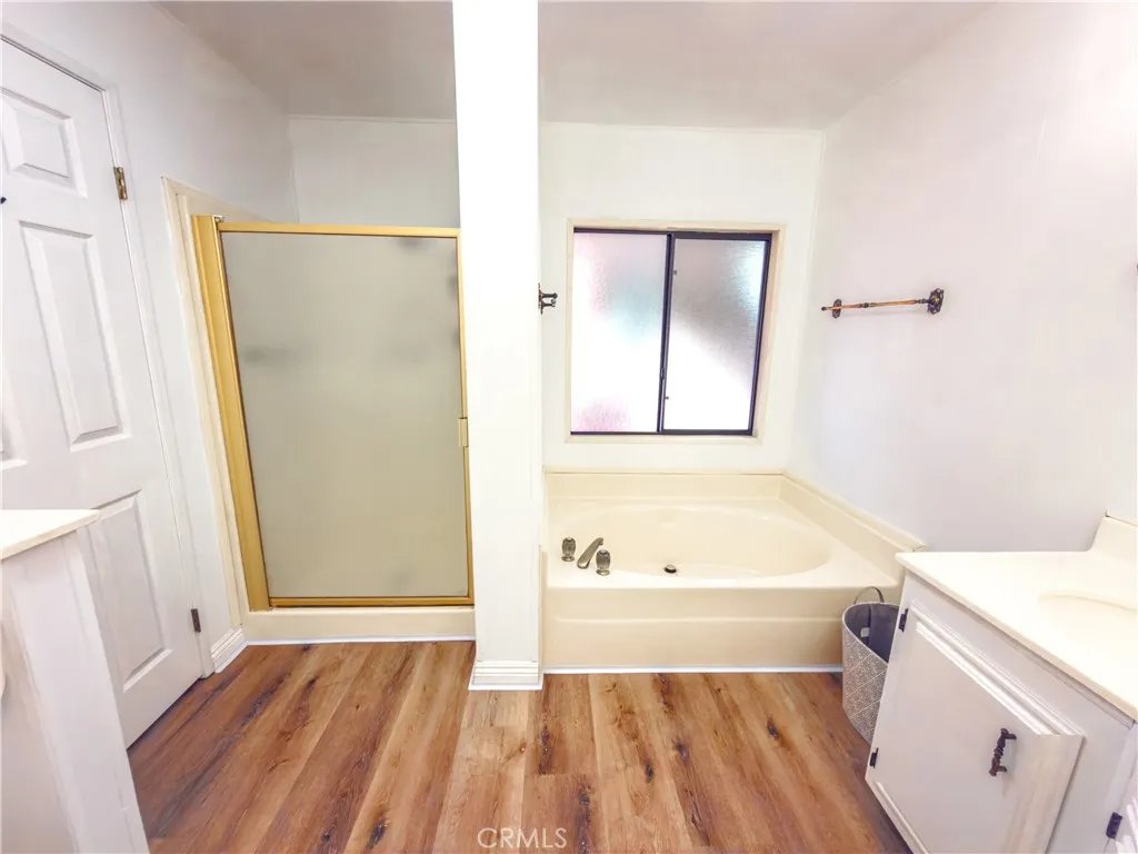 840 East Foothill Boulevard, Unit 203 Azusa, CA 91702 - Photo 23 of 45 a bathroom with a tub sink and a mirror