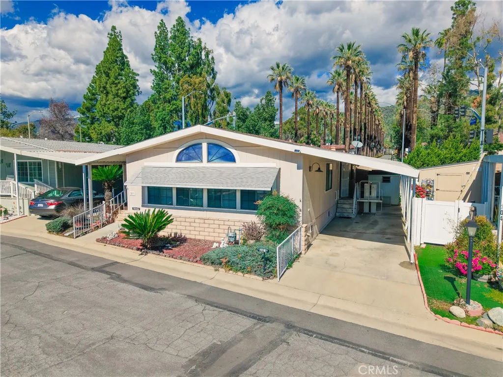 840 East Foothill Boulevard, Unit 203 Azusa, CA 91702 - Photo 3 of 45 a front view of a house with a yard and potted plants