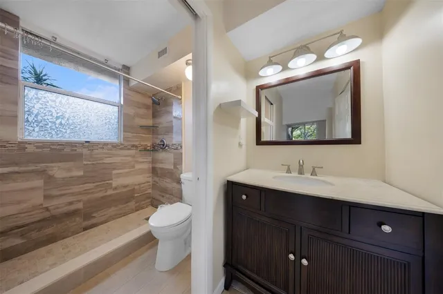 a bathroom with a toilet and a shower